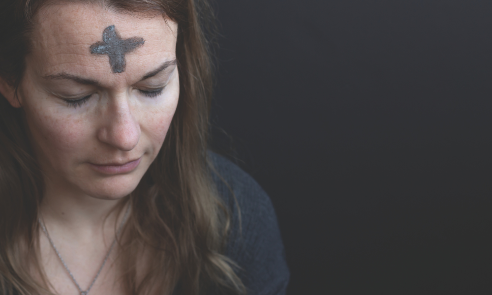 Women with ash cross on forehead